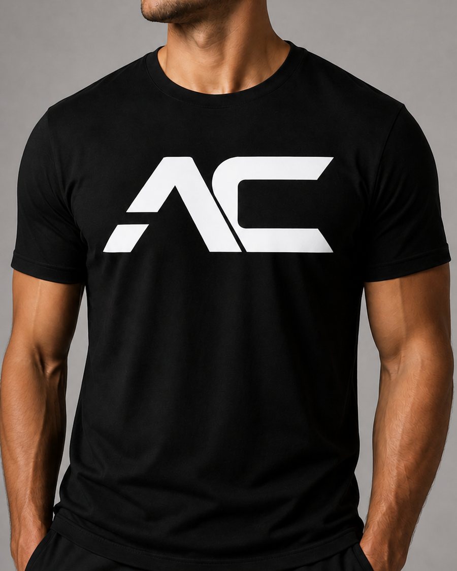 The Heavy Tee in black with the white AC mark, worn